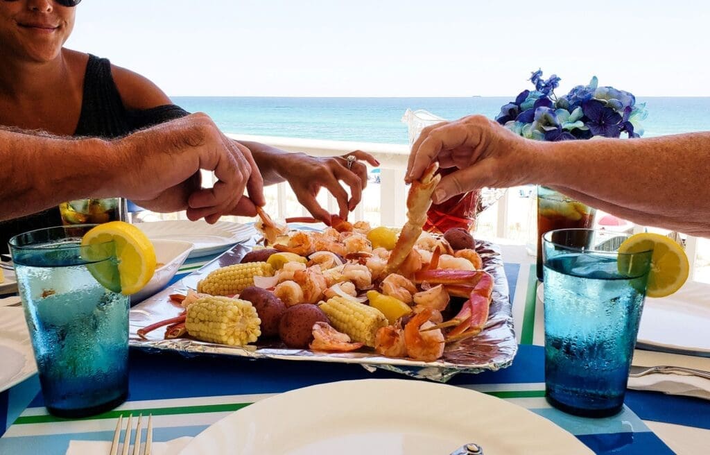 family on the beach eating boiled seafiid