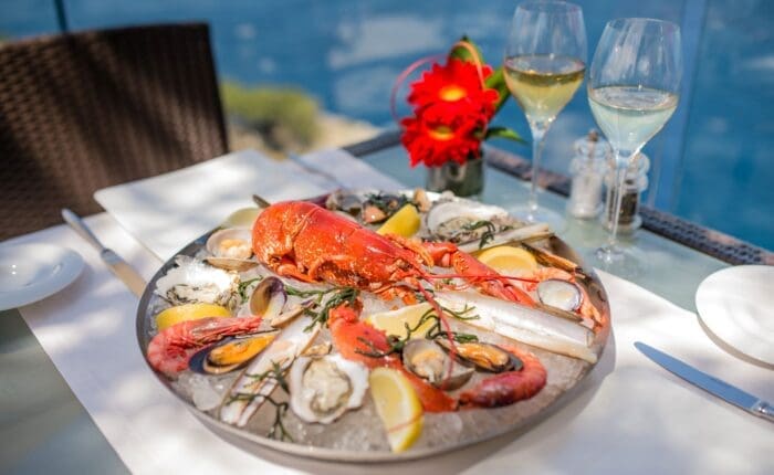 a chilled plate with lobster, prawns, oysters, and mussels